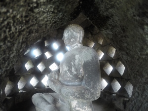 Buddha statue inside perforated stupa